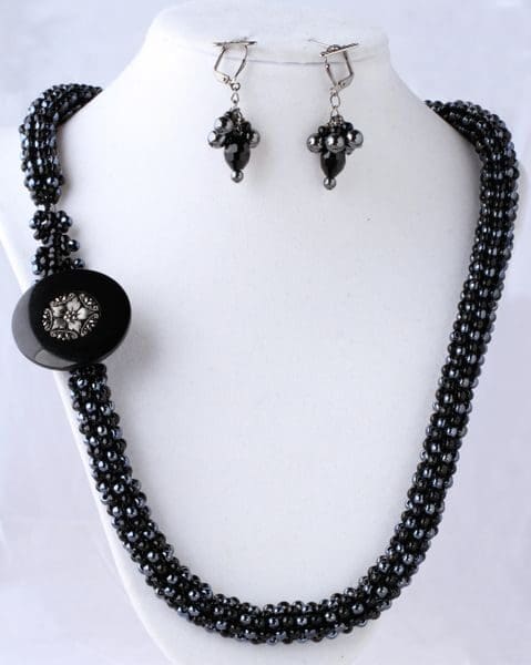 A necklace and earrings set with black beads.