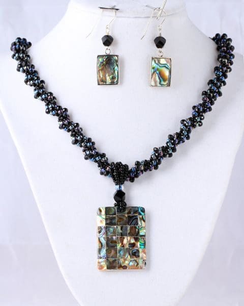 A necklace and earrings set with black beads