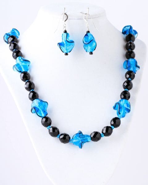 A necklace and earrings set with blue beads.