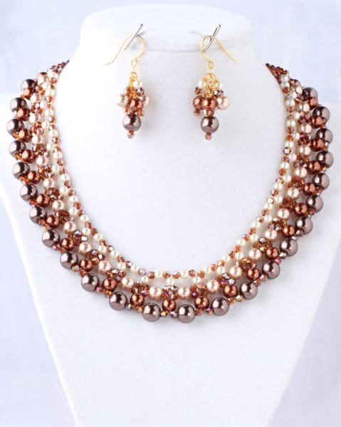 A necklace and earrings set of brown pearls