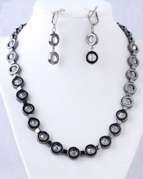 A necklace and earrings set with black and white beads.