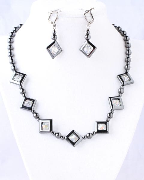 A necklace and earrings set with black beads.