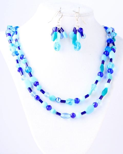 A necklace and earrings set of blue glass beads.