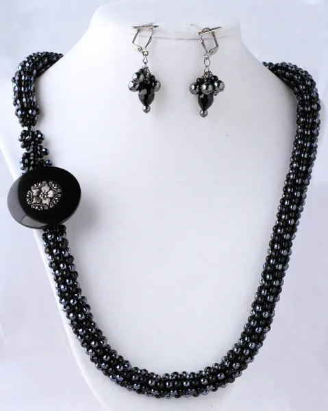 A necklace and earrings set with black beads.