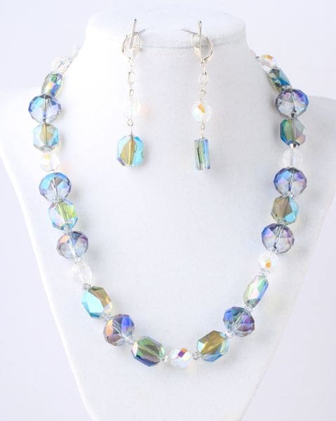 A necklace and earrings set with blue, green and white beads.