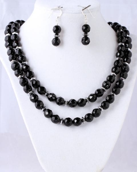 A necklace and earrings set with black beads.