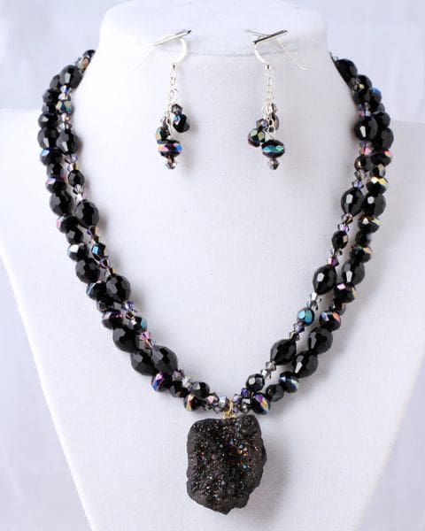 A necklace and earrings set with black beads