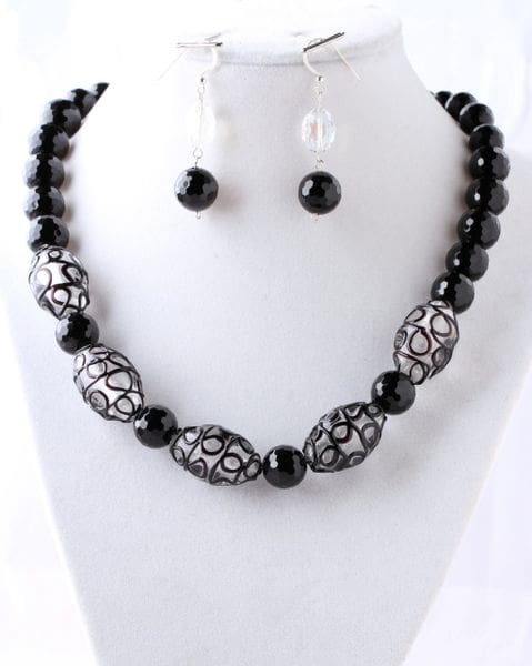 A black and silver necklace with matching earrings.