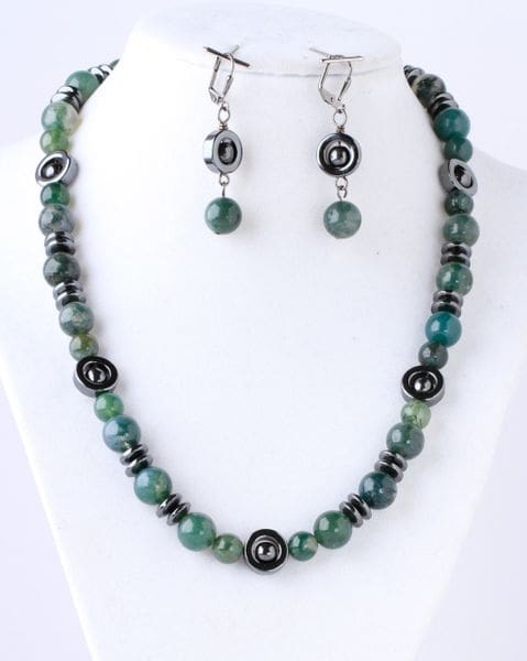 A necklace and earrings set with green beads.