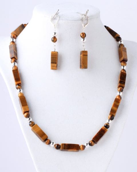 A necklace and earrings set made of tiger 's eye beads.