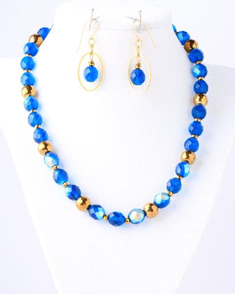 A necklace and earrings set with blue beads.