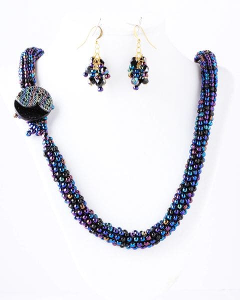 A necklace and earrings set with blue beads.