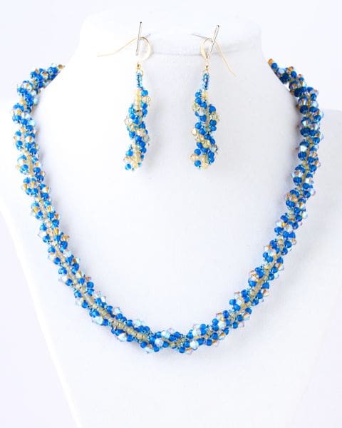 A necklace and earrings set with blue beads.