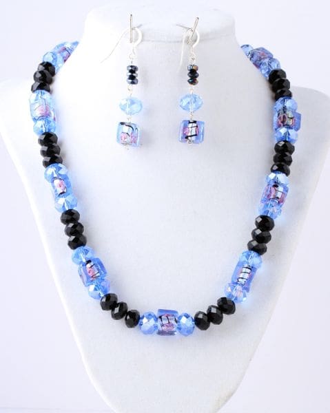 A necklace and earrings set with blue beads.