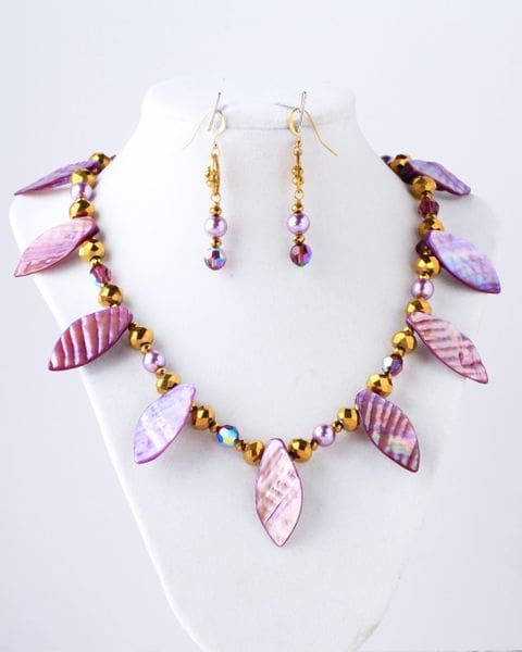 A necklace and earrings set with purple leaves.