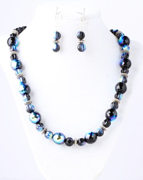 A necklace and earrings set with blue beads.