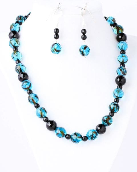 A necklace and earrings set with blue beads.