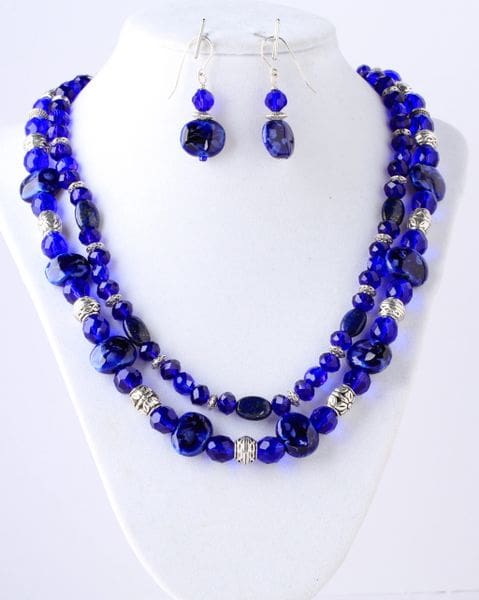 A necklace and earrings set with blue beads.