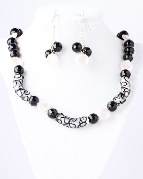 A necklace and earrings set with black beads.